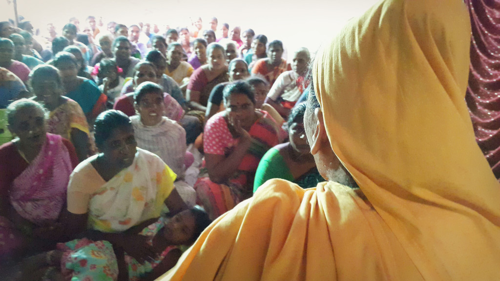 Swamiji lectures the women from the city's slums.